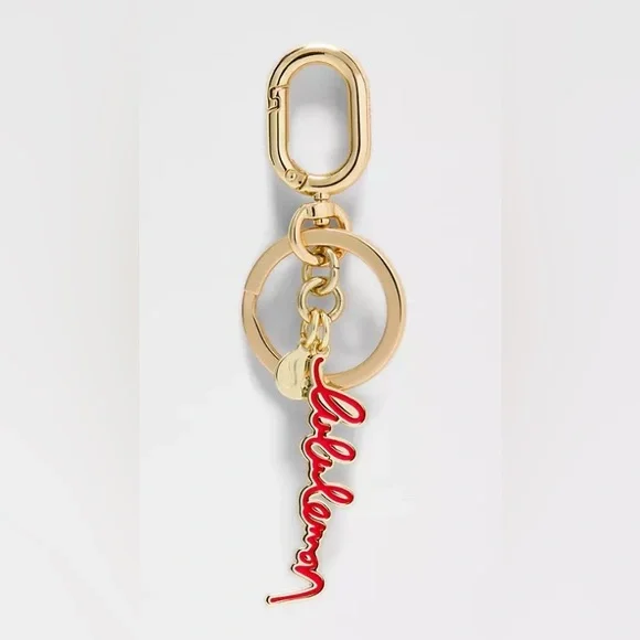 Lululemon keychain/ bag charm, red and gold tone - Picture 1 of 3